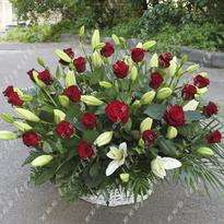 Mourning basket of lilies and red roses